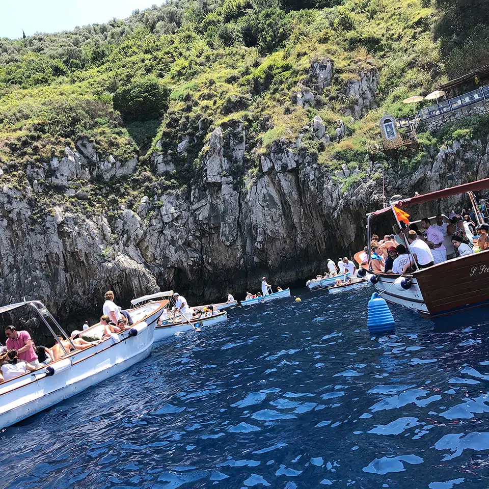 Outside and waiting in-line for a trip inside the Blue Grotto, Capri.