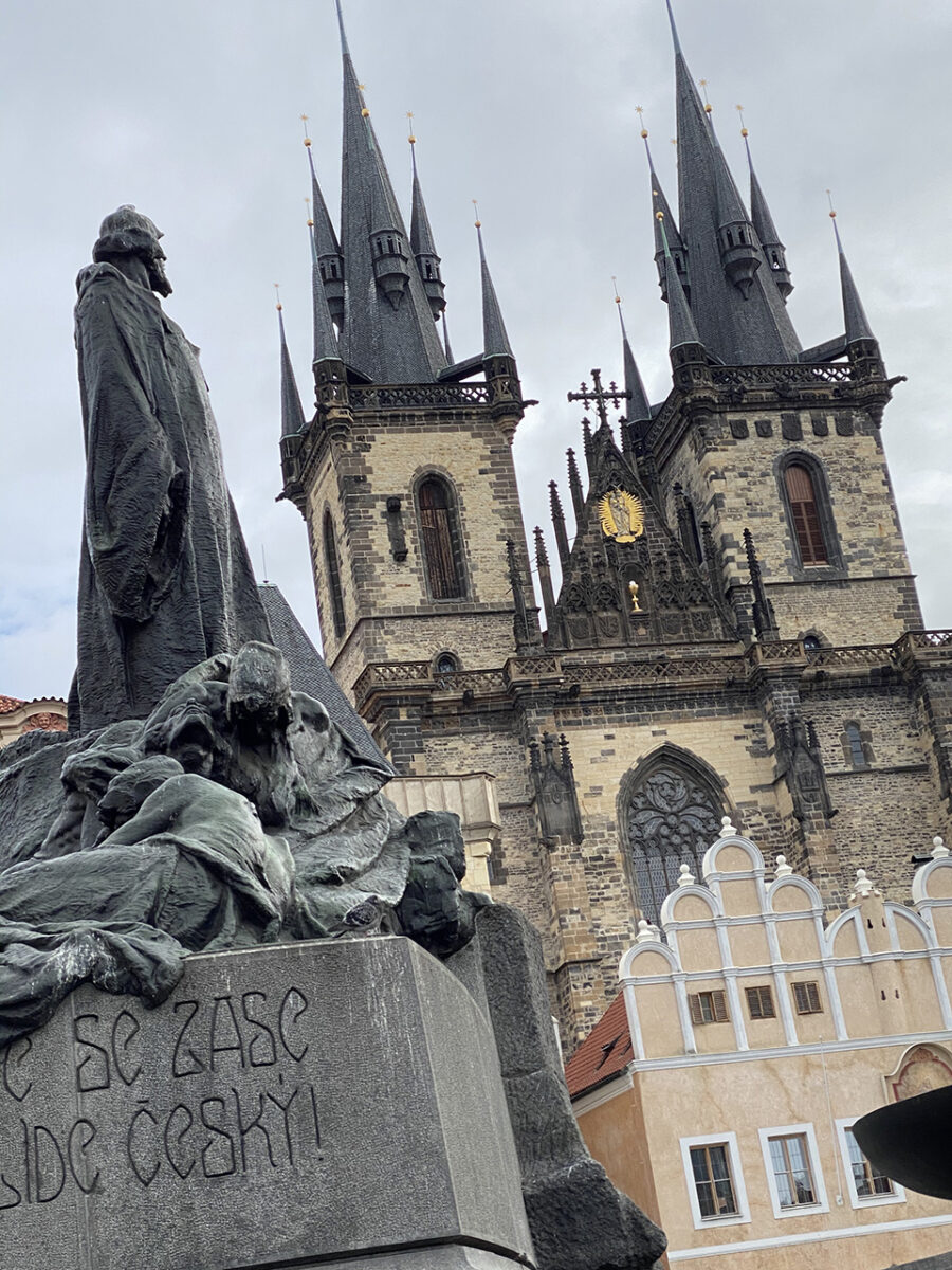 Church of Our Lady before Týn being gazed up on by the Jan Hus memorial.