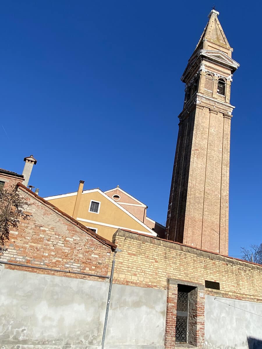 Visiting the Islands of Murano and Burano from Venice. The leaning bell tower.