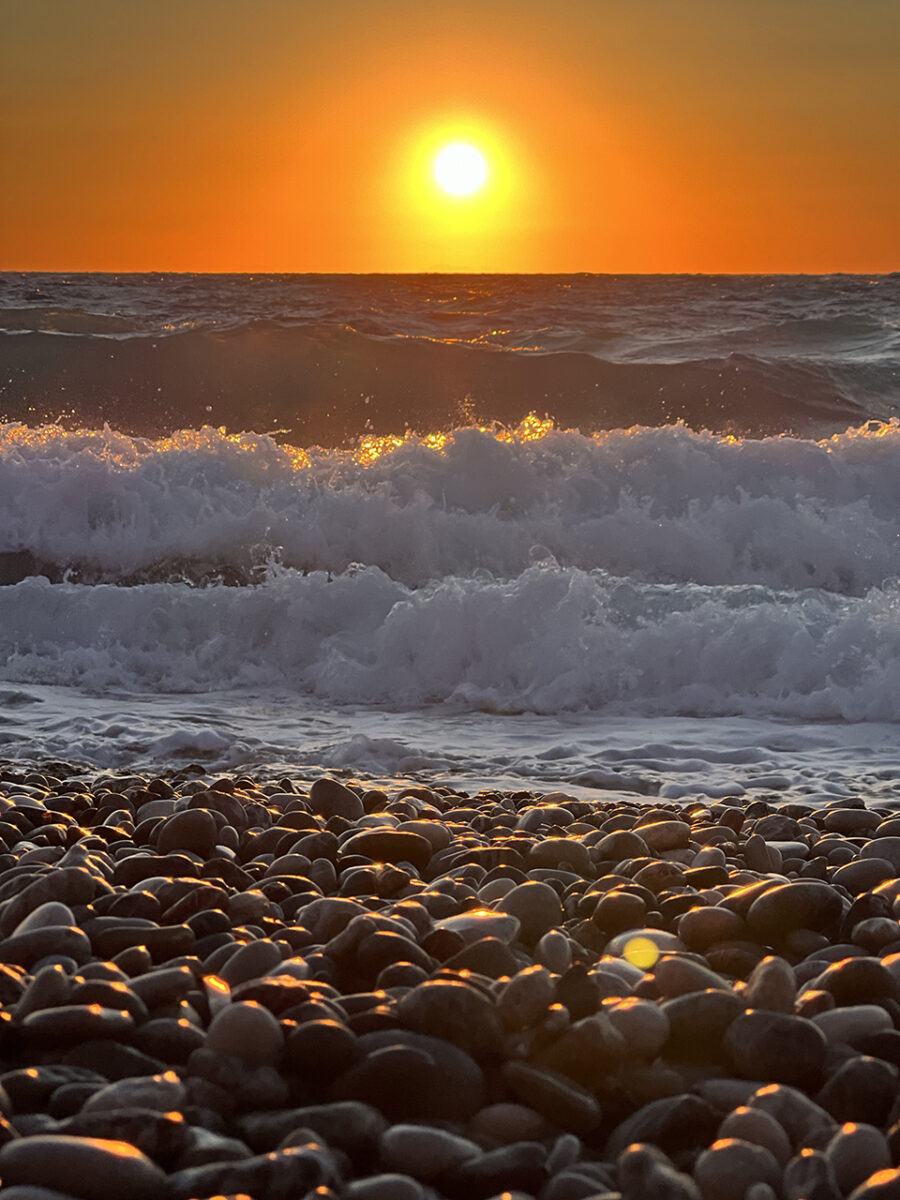 Sunset and waves crashing, Rhodes, Greece.
