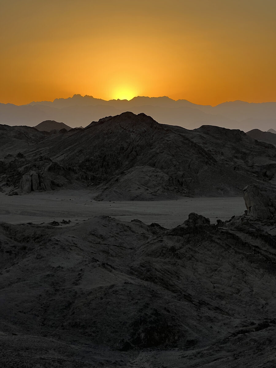 The sun sets over the desert mountains, Hurghada, Egypt.